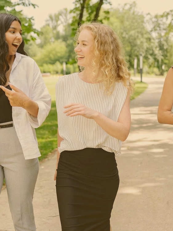women having a conversation while walking on a path